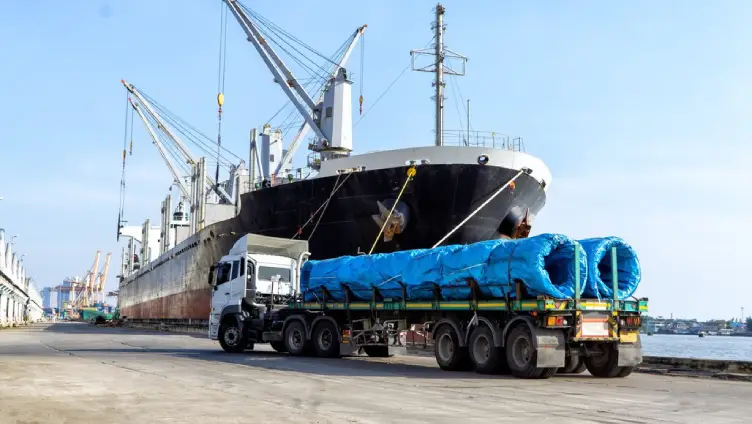 FLC Freight specialists securing heavy equipment for shipment